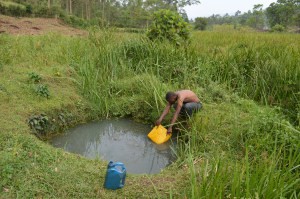 Chrispus Twikirize fetches water from their well in Ibaare, Igara Bushenyi district of Uganda