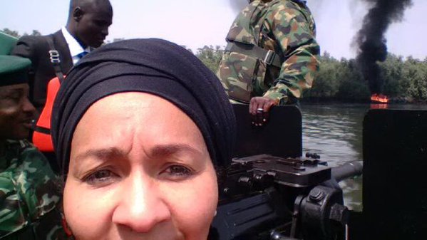 The Minister on a speed boat inspecting land and water bodies polluted by petroleum products in the Niger Delta