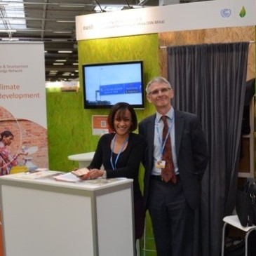 CDKN Chief Executive Sam Bickersteth and Head of Negotiations Support Kiran Sura welcome delegates to the CDKN stand in Paris. Photo credit: Geoff Barnard, CDKN