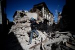 A man walks amid the rubble of buildings in the town of Amatrice on Wednesday after a powerful earthquake rocked central Italy. Photo credit: Filippo Monteforte/Getty