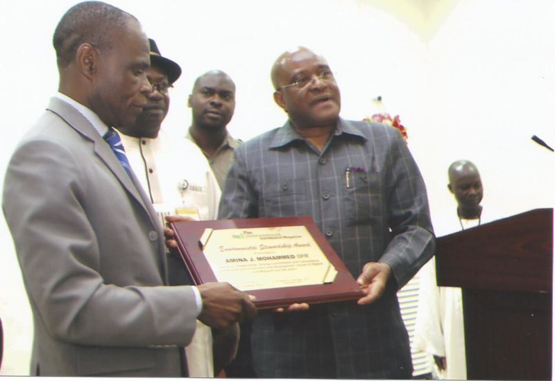 Former Minister of Environment, Sir John Odey (right) presenting an Environmental Award to the Minister of Environment, Amina Mohammed, through her representative, Dr. Lawrence Anukam, DG of NESREA